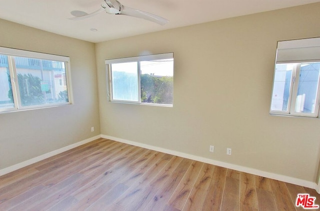 unfurnished room with ceiling fan and light wood-type flooring