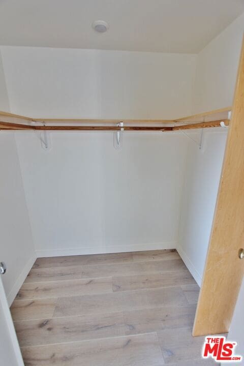 spacious closet with light wood-type flooring