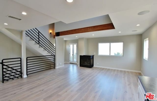 unfurnished living room with light hardwood / wood-style flooring and a fireplace