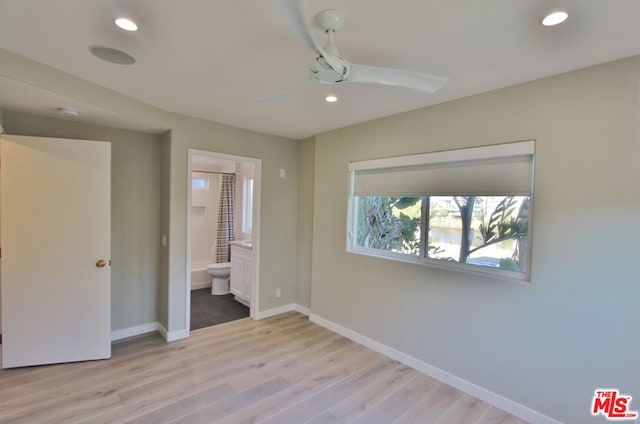 unfurnished bedroom with connected bathroom, ceiling fan, and light hardwood / wood-style floors