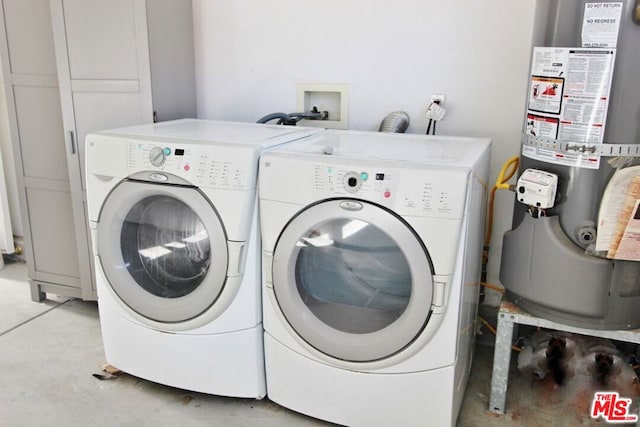 clothes washing area featuring separate washer and dryer and water heater