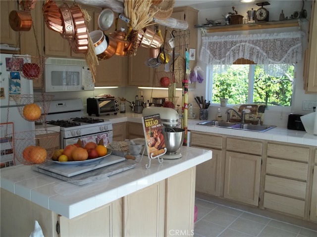 1647 Shire Ave, Oceanside, CA 92057 - kitchen with light tile patterned floors, tile countertops, white appliances, light brown cabinetry, and sink