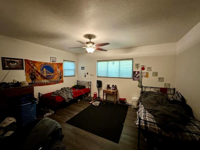 living room featuring hardwood / wood-style flooring, a textured ceiling, and ceiling fan