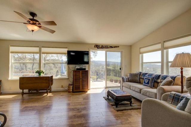 living room with hardwood / wood-style flooring, vaulted ceiling, and a wealth of natural light