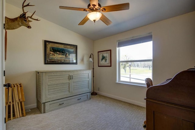 sitting room featuring lofted ceiling, light colored carpet, and ceiling fan