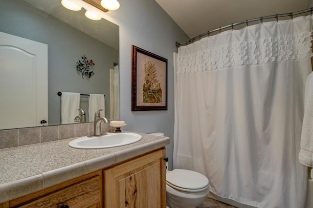 bathroom featuring vanity, toilet, and a shower with shower curtain