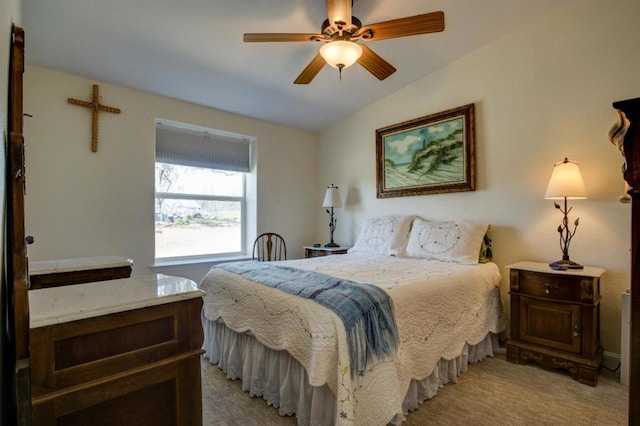 bedroom featuring vaulted ceiling, light carpet, and ceiling fan