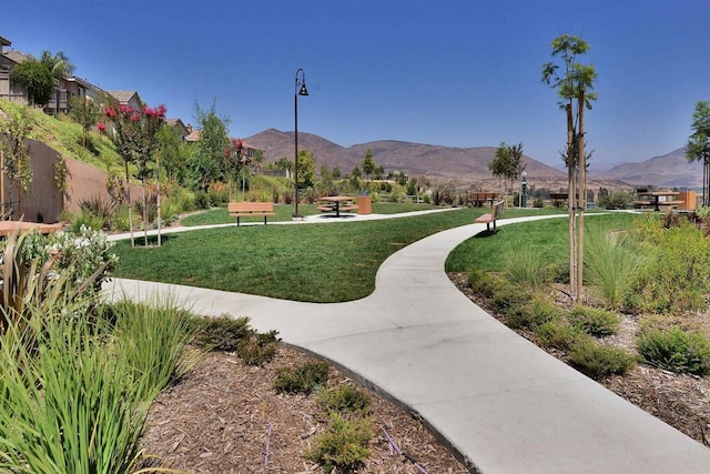 surrounding community featuring a lawn and a mountain view