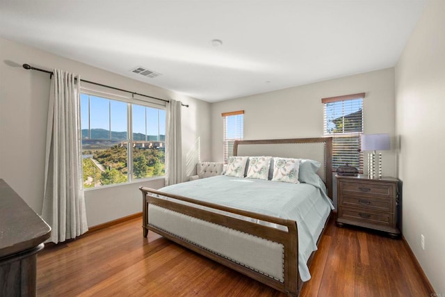 bedroom featuring a mountain view and wood-type flooring