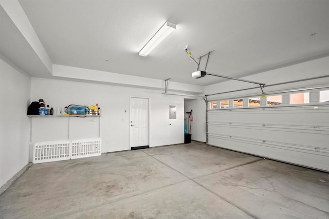 garage featuring electric panel and a garage door opener