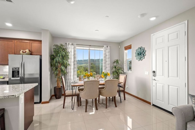 dining space featuring light tile patterned floors