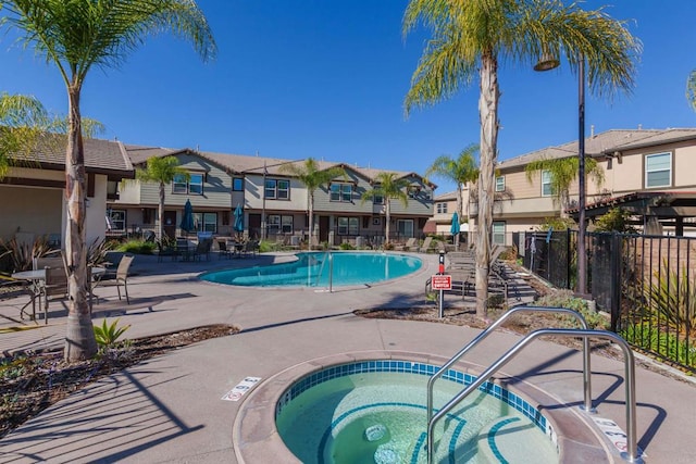 view of swimming pool with a community hot tub