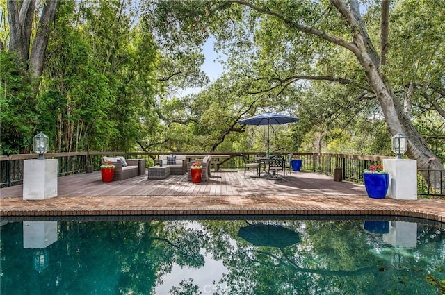 view of pool featuring a deck and an outdoor hangout area