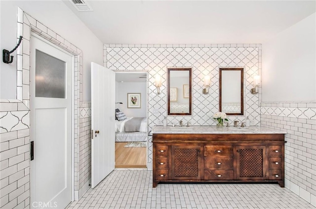 bathroom featuring tile patterned floors, vanity, and tile walls