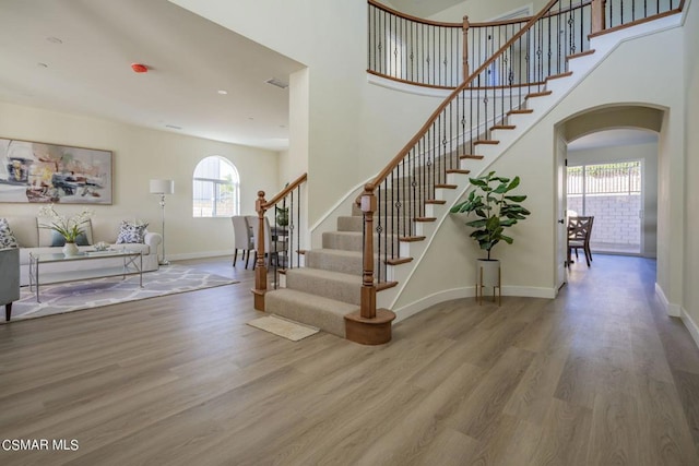 staircase featuring hardwood / wood-style flooring and a wealth of natural light