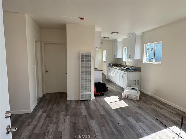 kitchen featuring dark hardwood / wood-style flooring, sink, and white cabinets