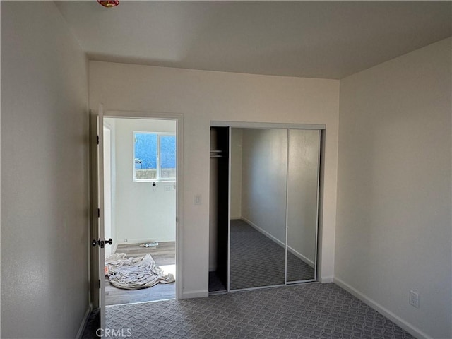 unfurnished bedroom featuring carpet floors and a closet