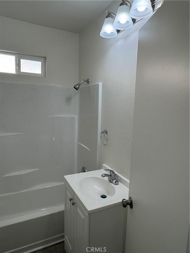 bathroom featuring vanity, a notable chandelier, and  shower combination