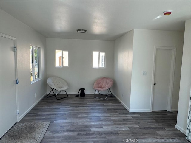 unfurnished room with dark wood-type flooring