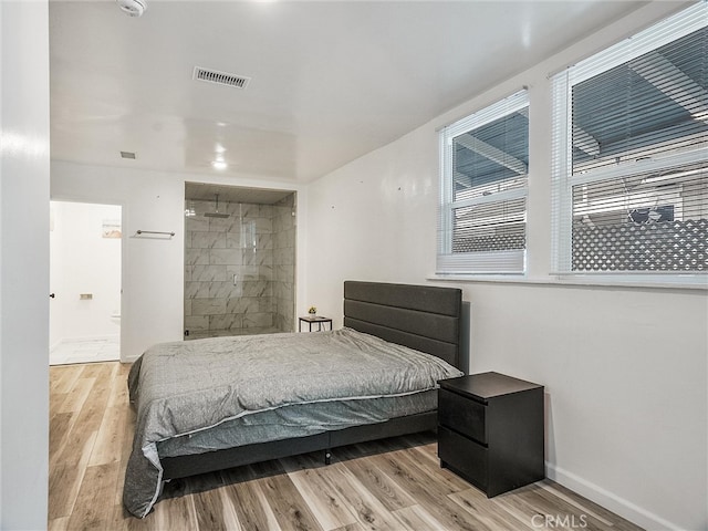 143 N Hobart Blvd, Los Angeles, CA 90004 - bedroom with light hardwood / wood-style flooring and ensuite bathroom
