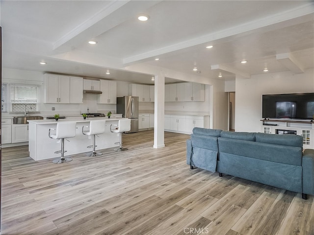 143 N Hobart Blvd, Los Angeles, CA 90004 - living room with beamed ceiling, sink, and light wood-type flooring