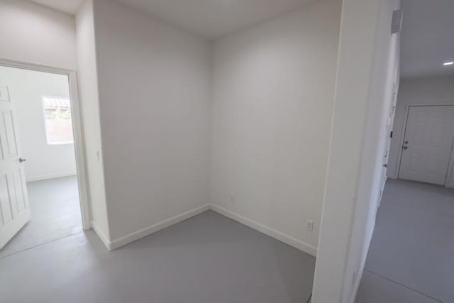 unfurnished room with concrete flooring