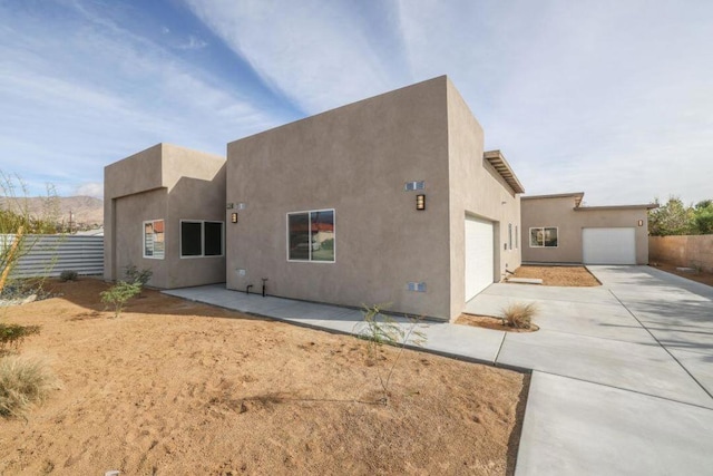 back of property with a garage