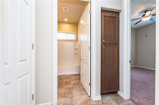 corridor with light colored carpet