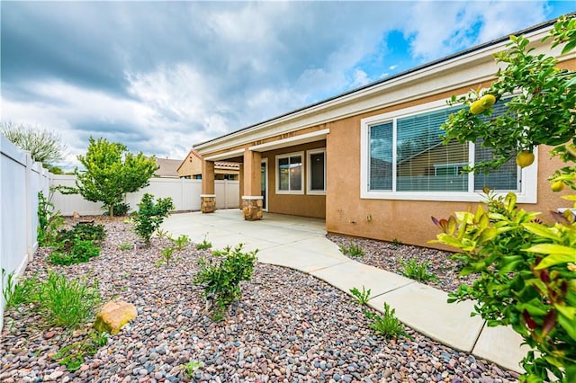 back of property featuring a patio