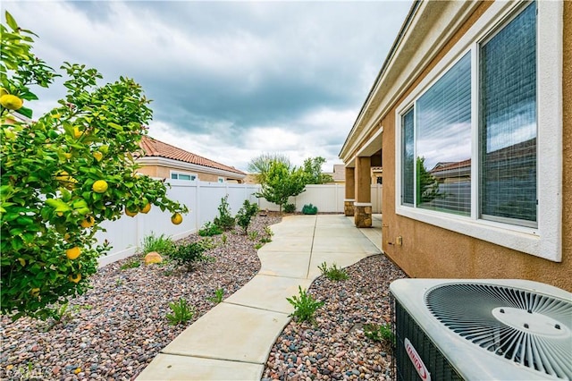 view of yard featuring a patio area and central air condition unit