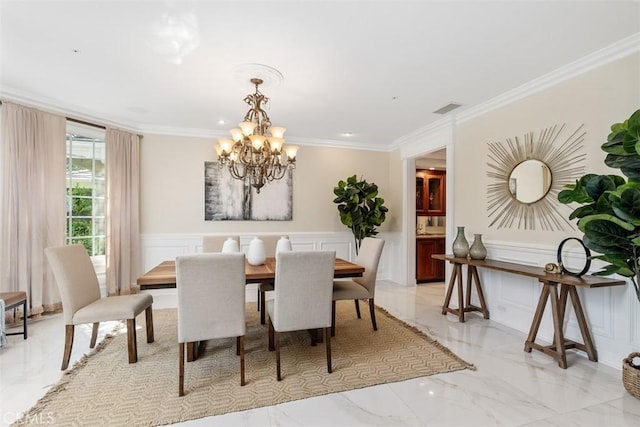 dining area featuring crown molding and a notable chandelier