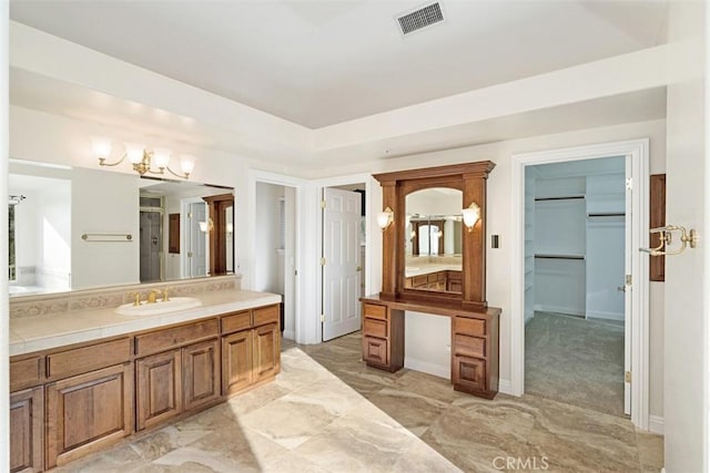 bathroom with vanity and a notable chandelier