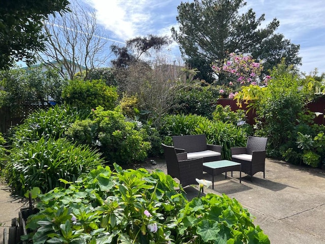 view of community featuring an outdoor living space and a patio