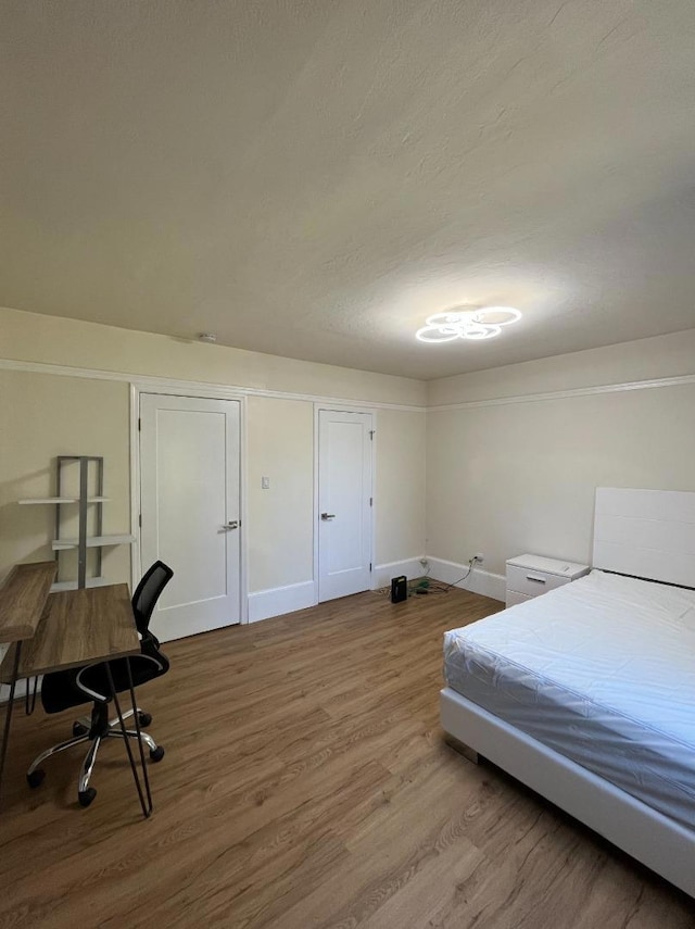 bedroom with hardwood / wood-style floors