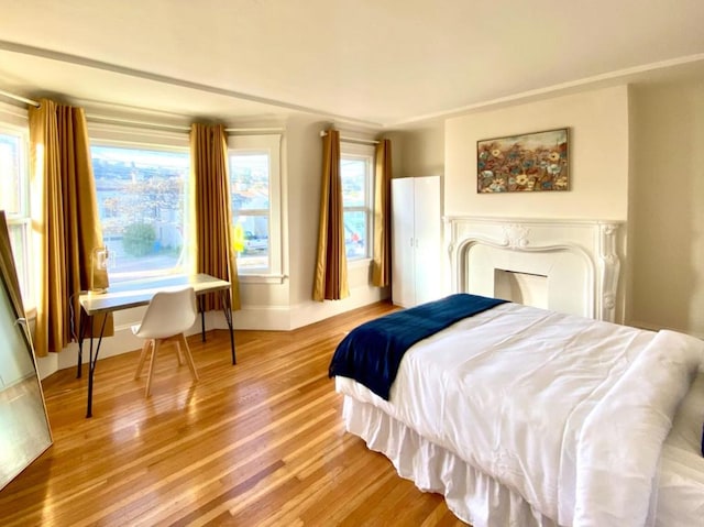 bedroom featuring hardwood / wood-style floors and multiple windows