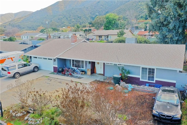 ranch-style house with a mountain view and a garage