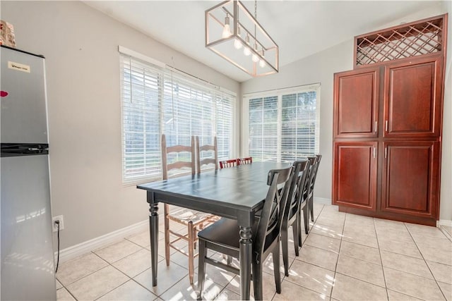 tiled dining area featuring a chandelier