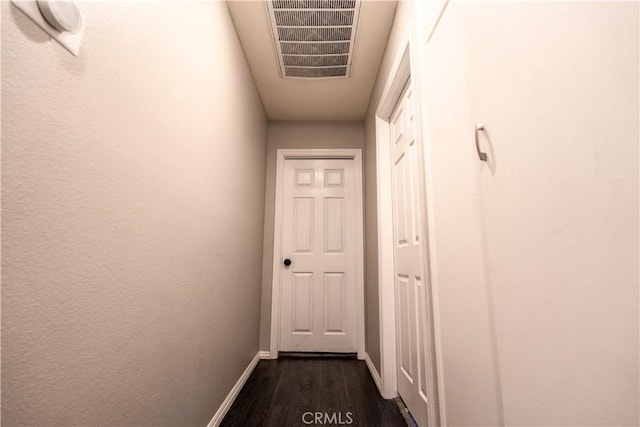 corridor with dark hardwood / wood-style flooring