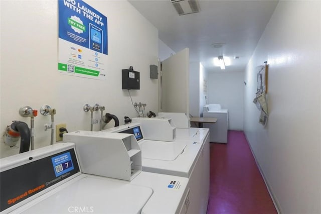 clothes washing area featuring independent washer and dryer