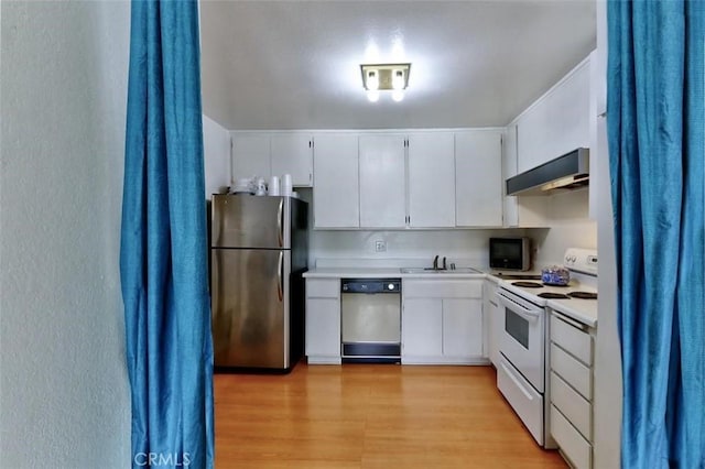 kitchen featuring white cabinetry, sink, stainless steel appliances, and range hood