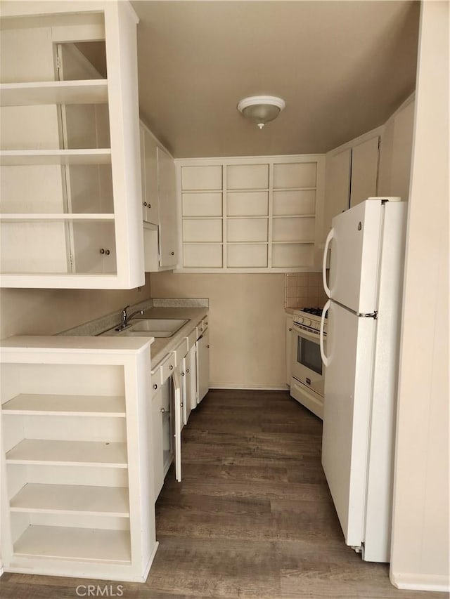 kitchen featuring white appliances, backsplash, sink, dark hardwood / wood-style flooring, and white cabinetry