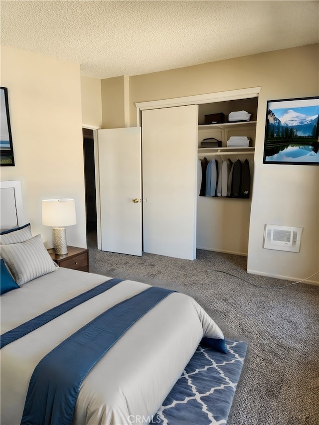 carpeted bedroom with a closet and a textured ceiling