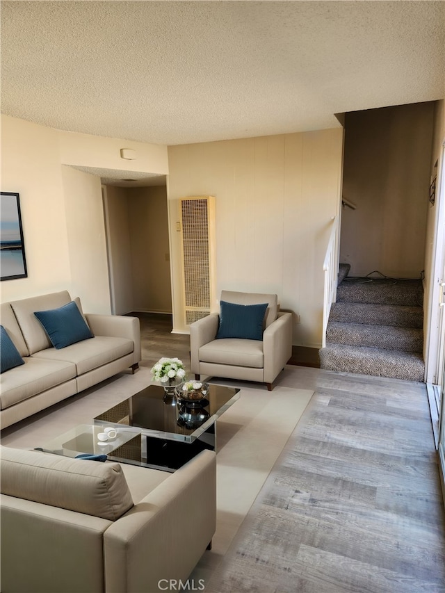 living room with light hardwood / wood-style flooring and a textured ceiling