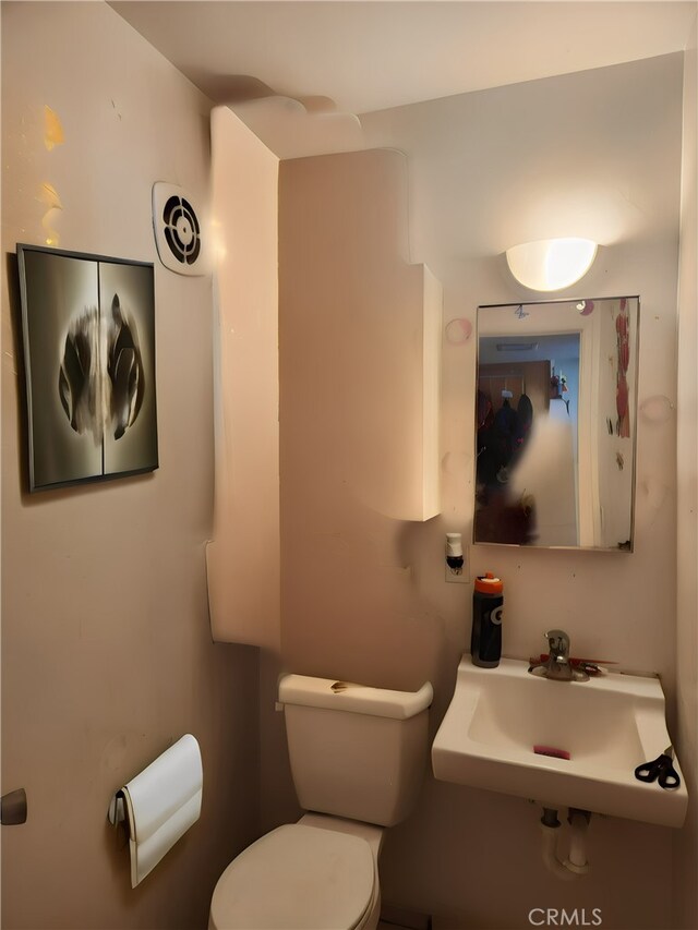 bathroom featuring sink and toilet