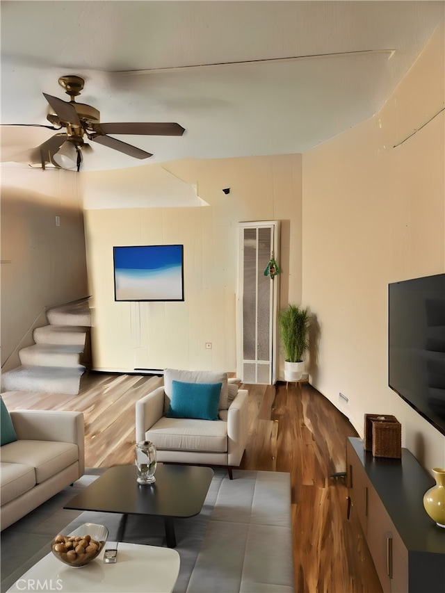 living room featuring hardwood / wood-style flooring and ceiling fan