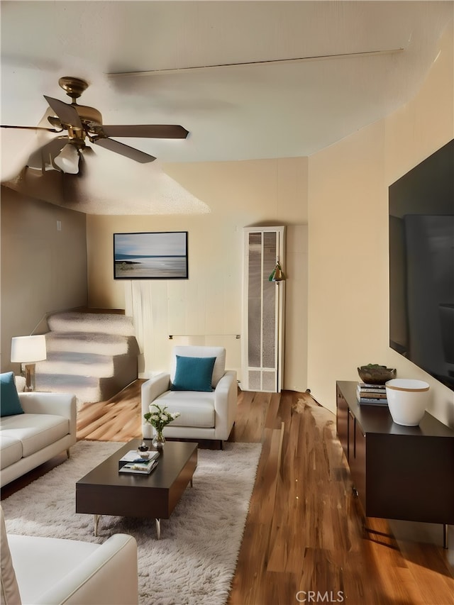 living room with ceiling fan and dark hardwood / wood-style floors