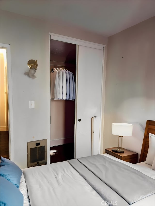 bedroom featuring a closet and heating unit