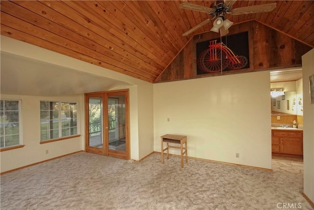 unfurnished living room featuring sink, wooden ceiling, ceiling fan, high vaulted ceiling, and light colored carpet