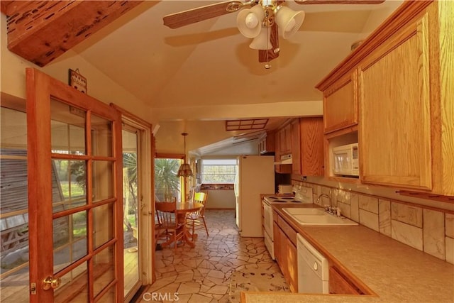 kitchen featuring white appliances, ceiling fan, sink, decorative light fixtures, and lofted ceiling