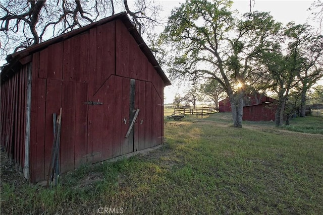 view of outbuilding with a lawn